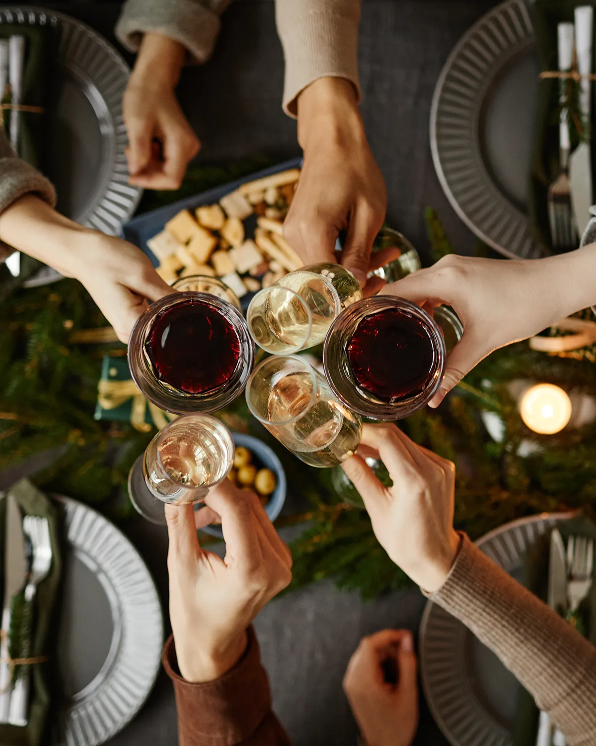 People enjoying glasses of wine around restaurant table